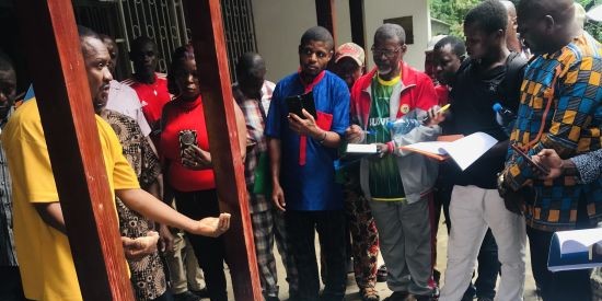Image of several men listening to another man.